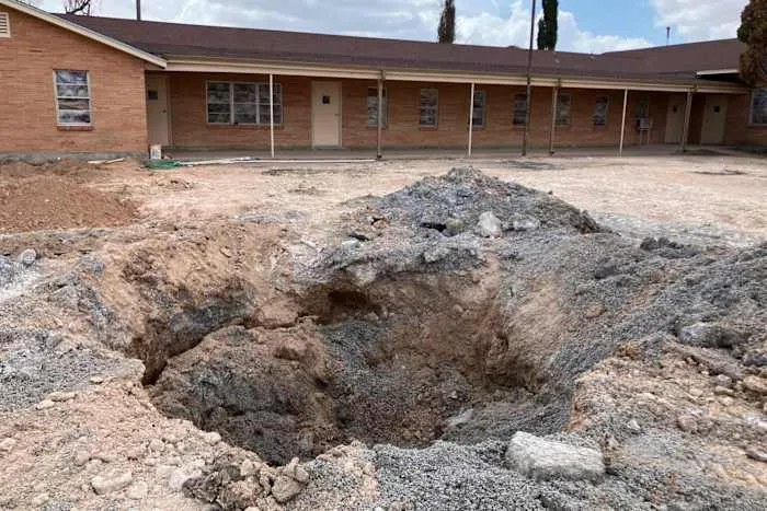 An old well began gushing oilfield wastewater in a West Texas church parking lot, sparking a costly cleanup